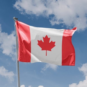 Puede incluir: Una bandera canadiense ondeando al viento contra un cielo azul con nubes blancas.