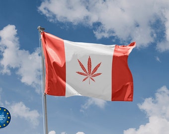 May include: A Canadian flag with a red marijuana leaf in the center, waving in the wind against a blue sky with white clouds.