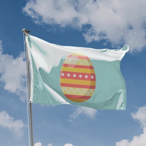 May include: A light blue flag with a yellow and red Easter egg design. The egg has a white zigzag pattern, yellow stripes, and red lines.