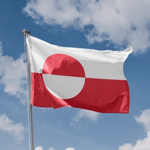 May include: A red and white flag with a large white circle in the centre, divided by a horizontal white line. The flag is waving in the wind against a blue sky with white clouds.