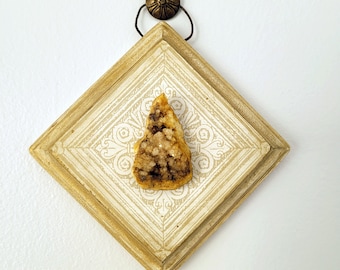 small assemblage of wood, paper and stone. sculptures featuring a geode and vintage wallpaper mounted on painted wood and hung by wire