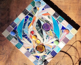 an abstract coi splash. fine art mosaic on wood with stained glass & glass tile. decorative indoor mosaic art