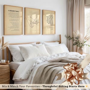 a cozy bedroom with a large bed, framed wall art, and a decorative bow on the bed. The room has a minimalist and elegant design, with a focus on the bed and its accessories.
