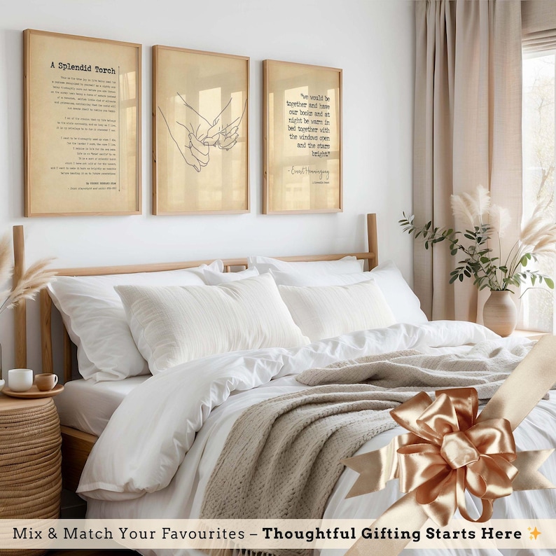a cozy bedroom with a large bed, framed wall art, and a decorative bow on the bed. The room has a minimalist and elegant design, with a focus on the bed and its accessories.