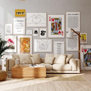 a living room filled with furniture and pictures on the wall