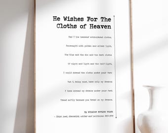 May include: A framed print featuring the poem "He Wishes For The Cloths of Heaven" by William Butler Yeats. The text is in black on a white background, with the author's name and dates at the bottom. The frame is a light brown color.