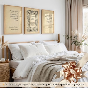 a bedroom with a bed, framed quotes, and a decorative bow on the bed.