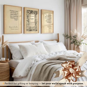 a bedroom with a bed, framed quotes, and a decorative bow on the bed.