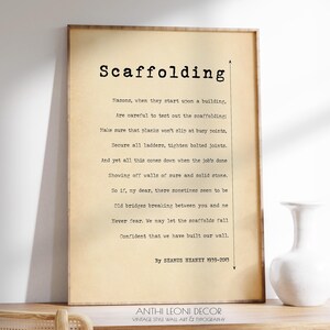 Framed Scaffolding Poem Print sitting on a desk against the wall