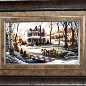 May include: A framed winter scene painting of a horse-drawn wagon carrying a Christmas tree through a snowy village. The painting features a red-roofed house with a white porch and a church in the background.