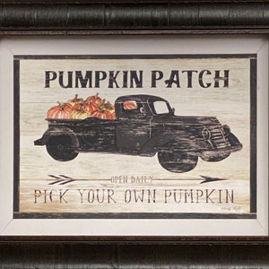 May include: Framed artwork featuring a vintage black truck filled with pumpkins. The text "PUMPKIN PATCH" is at the top, with "PICK YOUR OWN PUMPKIN" below. The artwork has a rustic, farmhouse style, perfect for autumn decor.