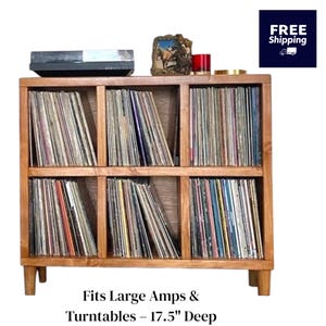May include: A wooden record storage shelf with 12 compartments, each filled with vinyl records. The shelf is 17.5 inches deep and is designed to fit large amplifiers and turntables.  Fits Large Amps & Turntables - 17.5" Deep