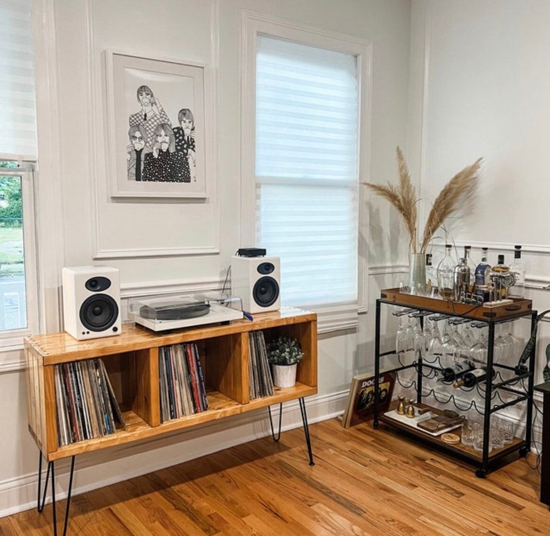 Record player stand three sectional with record storage in the antique walnut stain. Durable wood. With upgraded 16" hairpin legs (longer legs are optional) White record player and speakers up top, displayed in beautiful living room