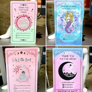 May include: Four different business cards with a watercolour background and illustrations. The first card is green and pink with a moon and stars and the text "not every libra". The second card is blue and pink with a mermaid and the text "Jess de la Mer". The third card is pink with a bird and the text "Lily Little Bird". The fourth card is pink and blue with a crescent moon and the text "Mythica Dice".
