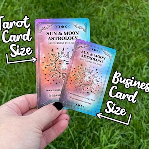 May include: Two business cards with a galaxy background. The larger card is labelled "Tarot Card Size" and the smaller card is labelled "Business Card Size". Both cards feature a sun and moon design with the text "Sun & Moon Astrology" and website information.