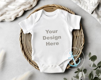 White baby onesie flatlay mockup, infant bodysuit on a boho style background with eucalyptus leaves, gray background, kid t-shirt mockup