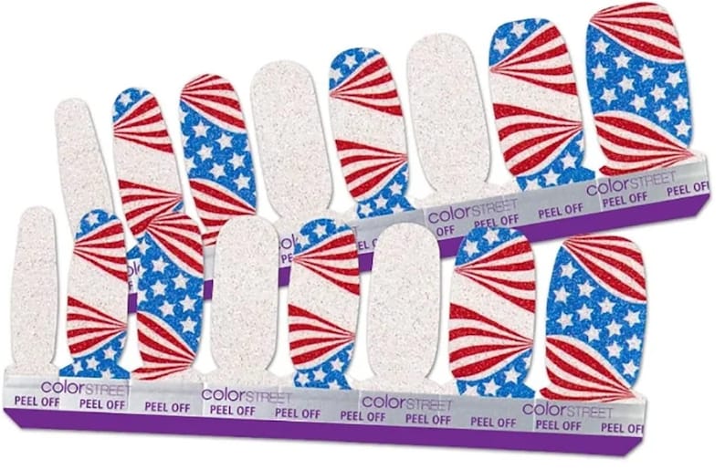 May include: A set of 10 nail polish wraps featuring a red, white and blue American flag design with glitter. The wraps are labelled "Color Street" and "Peel Off".