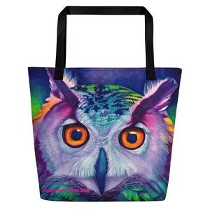 May include: A colorful tote bag featuring a close-up of an owl with bright orange eyes. The owl's feathers are painted in shades of purple, blue, green, and pink. The bag has black handles and a white background with the text "studiopeterson.com" in the bottom corner.