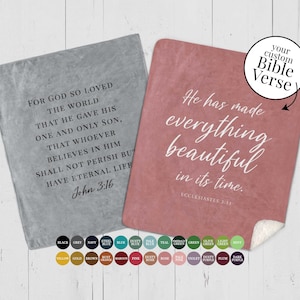 May include: Two fleece blankets with inspirational Bible verses printed on them. The left blanket is grey with the verse "For God so loved the world that he gave his one and only Son, that whoever believes in him shall not perish but have eternal life. John 3:16". The right blanket is pink with the verse "He has made everything beautiful in its time. Ecclesiastes 3:11". A colour chart of 24 colours is shown below the blankets.
