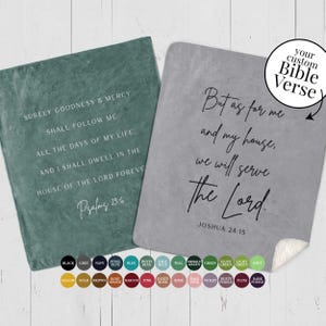 May include: Two fleece blankets with inspirational Bible verses printed on them. The left blanket is teal green with the verse "Surely goodness and mercy shall follow me all the days of my life. And I shall dwell in the house of the Lord forever. Psalms 23:6". The right blanket is grey with the verse "But as for me and my house, we will serve the Lord. Joshua 24:15".