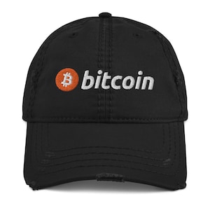 May include: Black distressed baseball cap with the word "bitcoin" embroidered in white. The bitcoin logo, an orange circle with a white "B" in the center, is on the left side. The cap has a pre-worn, vintage look.