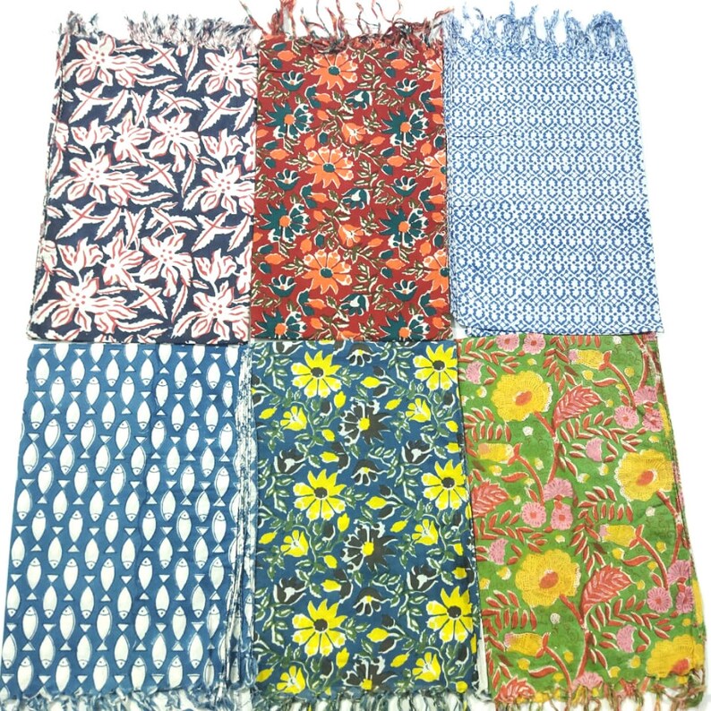 May include: Six different fabric swatches with various floral and geometric patterns. The swatches are in shades of blue, green, red, and yellow.