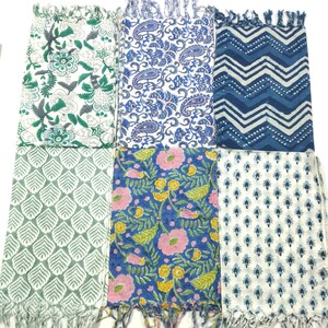 May include: Six different cotton scarves with various patterns. The scarves are all white with blue, green, and pink accents. The patterns include paisley, floral, and geometric designs.