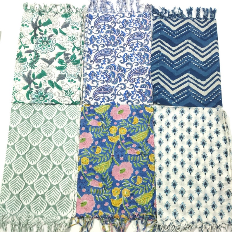 May include: Six different cotton scarves with various patterns. The scarves are all white with blue, green, and pink accents. The patterns include paisley, floral, and geometric designs.