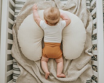 baby sleeping on breastfeeding pillow