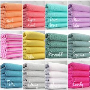 May include: Ten different colors of striped kitchen towels, stacked in four layers. The colors are peach fuzz, light coral, dark mint, new lilac, yellow, emerald, spruce, tide, gray, and candy.