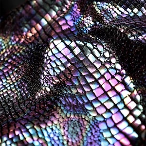 May include: Close-up of iridescent fabric with a reptile scale pattern. The fabric has a dark base color with shimmering highlights of purple, blue, and green. The scales are small and tightly packed, creating a textured surface.