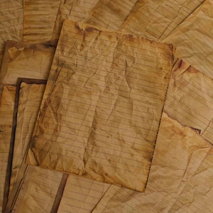 May include: A collection of aged, lined paper sheets with a sepia tone. The paper has visible creases and stains, suggesting a vintage or antique aesthetic. The sheets are arranged in a layered composition, creating a textured, tactile appearance.