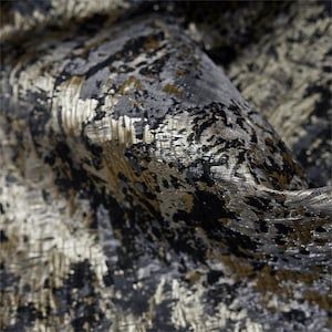 May include: Close-up of a textured fabric with a metallic sheen. The fabric features a blend of black, grey, and gold colours, creating a luxurious and abstract pattern. The material appears to be folded, showcasing its depth and texture.