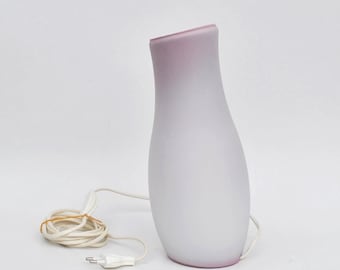 May include: A white and pink glass table lamp with a cord and plug.