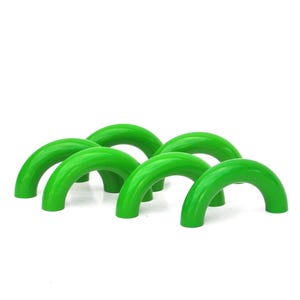 May include: Six bright green, arched wooden toys are arranged on a white background. Each arch has a rounded top and two short legs, creating a bridge-like shape. The toys are evenly spaced and appear to be part of a set.