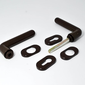 May include: A set of brown door handles with keyholes and escutcheons. The handles are made of metal and have a smooth finish.