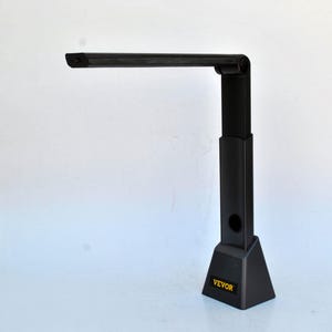 May include: A black desk lamp with a rectangular light head and an adjustable arm. The lamp has a triangular base with the word "VEVOR" printed in yellow. The lamp is designed for desk use.