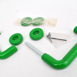 May include: An assortment of green, curved metal pieces, including two handles with textured grips, several circular components, and small screws. The parts are arranged on a white surface, suggesting a set of hardware or a component kit.