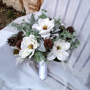 Winter Dreams magnolia wedding bouquet with matching pinecone boutonniere