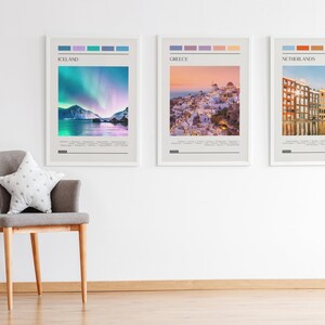 May include: Three framed travel posters with colorful stripes at the top and a scenic image below. The posters are titled "Iceland", "Greece", and "Netherlands".