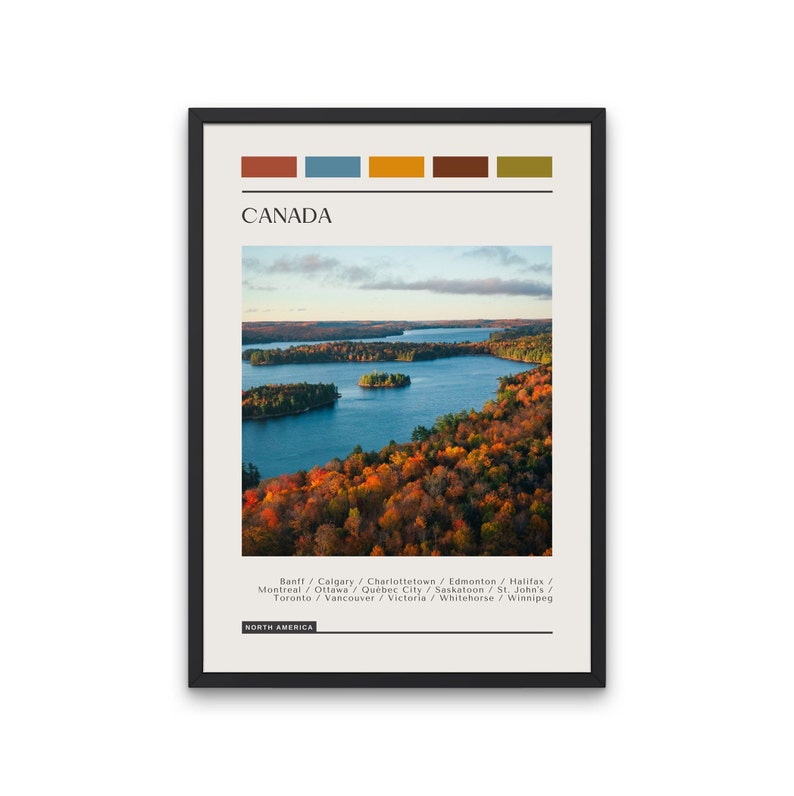 May include: A poster with a scenic image of a lake surrounded by fall foliage in Canada. The poster features the text "CANADA" and a list of Canadian cities. The poster is framed in black.