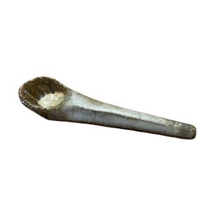 May include: A handmade ceramic spoon with a textured, speckled brown bowl and a long, slender handle. The handle transitions from a light, speckled color to a darker, mottled finish at the tip. The spoon is designed for serving or display.