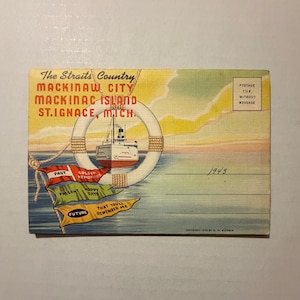 May include: Vintage postcard featuring a ship inside a life preserver, with flags reading "Past," "Present," and "Future." The postcard is labeled "Mackinaw City, Mackinac Island, St. Ignace, Mich." and includes a postage stamp area.