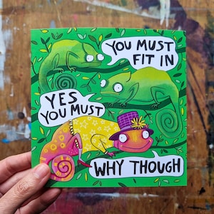 May include: A vibrant illustration shows three green chameleons on branches, with speech bubbles saying "You must fit in" and "Yes you must." A fourth chameleon, in a hat and yellow outfit, asks "Why though?"