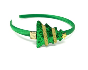 May include: Green satin headband with a green and gold glitter Christmas tree design.