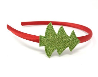 May include: A red headband with a green glitter Christmas tree design.
