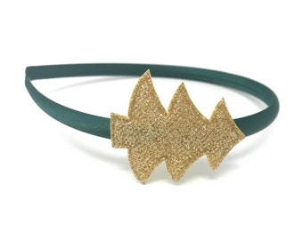 May include: A green headband with a gold glitter Christmas tree design.