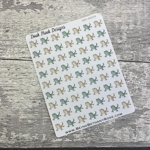 May include: A sheet of stickers featuring a repeating pattern of cartoon bearded dragons in green and beige colours. The sheet is labelled "Dook Plook Designs" and "DPD-D0059". The bottom of the sheet includes the website "WWW.BEINGBETHANYROSE.COM".