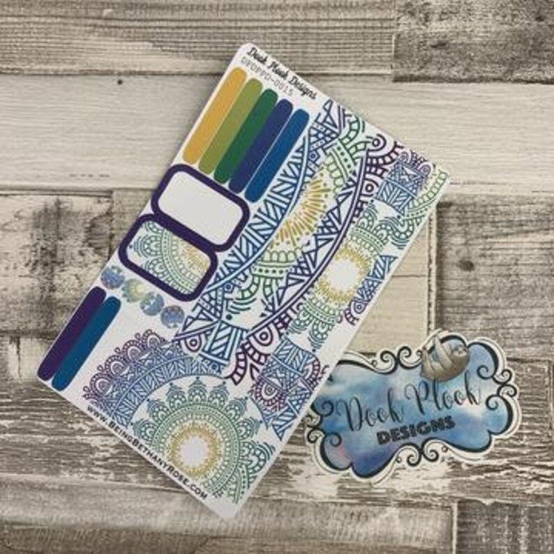 May include: A set of planner stickers featuring a colorful mandala design with blue, green, yellow, and purple accents. The stickers include a variety of shapes and sizes, including circles, squares, and rectangles. The text "Doodh Plooh Designs" is visible in the top left corner of the image.