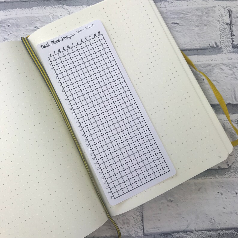 May include: A white gridded planner page with the text "Dook Plook Designs DPD-1336" and "JFMAMJJASOND" at the top. The page is numbered from 1 to 31.